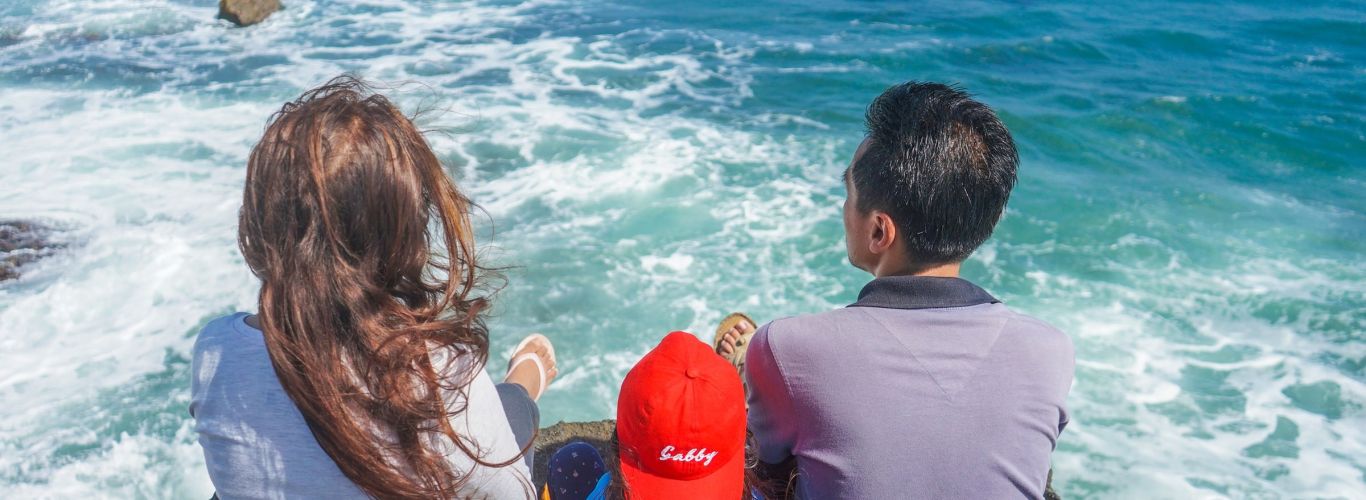 Family sitting on cliff edge