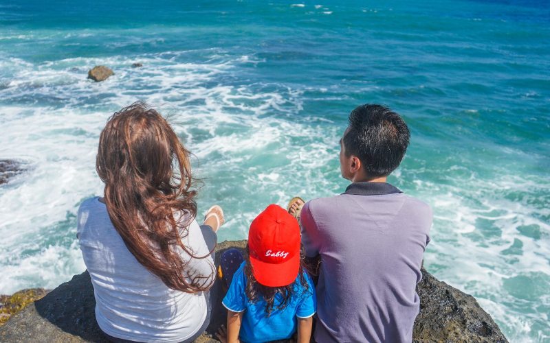 Family sitting on cliff edge